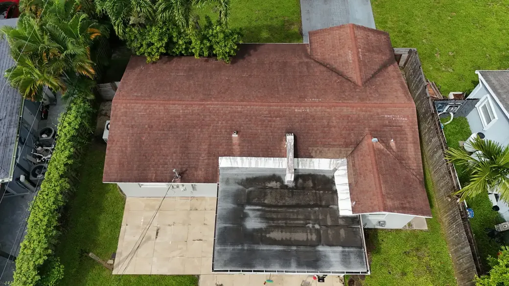 Drone photo of a Florida home, the flat roof section stained and marked for inspection