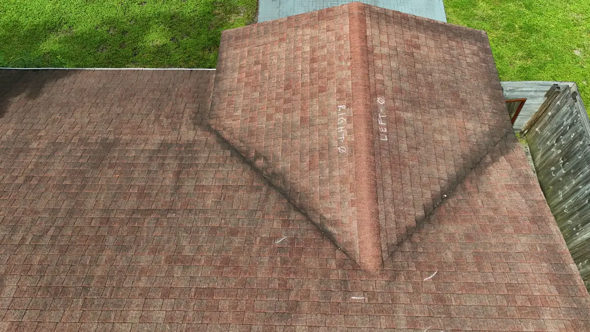 Drone view of a shingle roof with chalk test notes